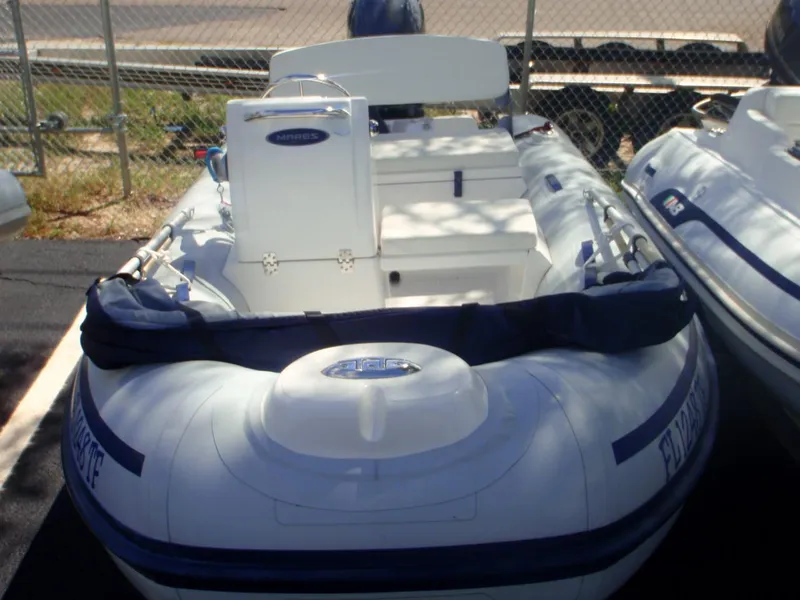 Slide: The Image of 2022 AB Inflatables Mares 11 VSX boat, white with blue accents, parked outdoors. - 5