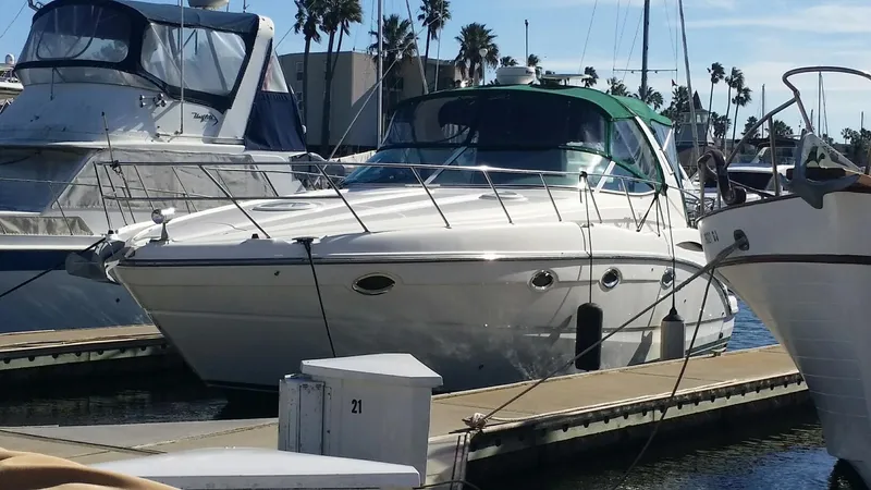 The Image of 2003 Maxum 3700 SCR yacht docked at marina with clear sky and palm trees. - 0