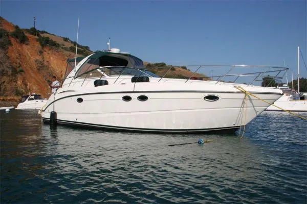 Slide: The Image of 2003 Maxum 3700 SCR yacht anchored in scenic bay. - 10