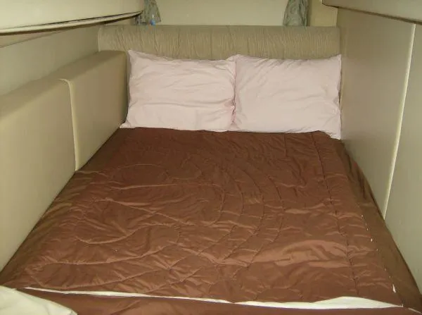 Slide: The Image of Cozy bed in 2003 Maxum 3700 SCR yacht cabin with brown bedding and pillows. - 2