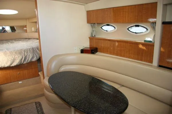 Slide: The Image of 2003 Maxum 3700 SCR yacht interior with leather seating and oval windows. - 4