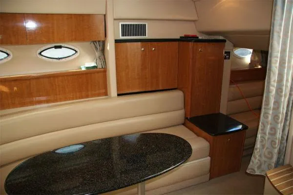 Slide: The Image of Luxurious interior of 2003 Maxum 3700 SCR yacht with wood cabinetry and plush seating. - 5