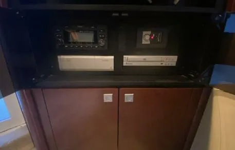 Slide: The Image of 2007 Sea Ray 36 Sedan Bridge interior electronics cabinet with stereo and DVD player. - 14