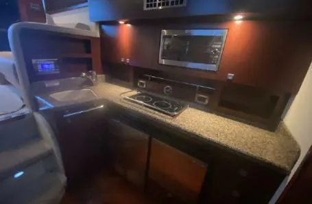 Slide: The Image of 2007 Sea Ray 36 Sedan Bridge kitchen with granite countertops and modern appliances. - 16