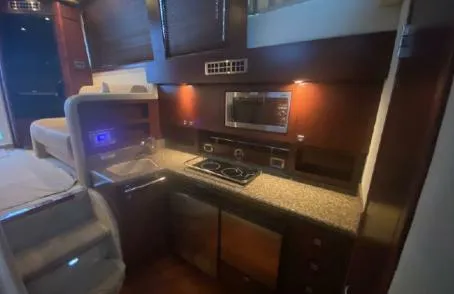 Slide: The Image of 2007 Sea Ray 36 Sedan Bridge yacht interior kitchen with modern appliances. - 17
