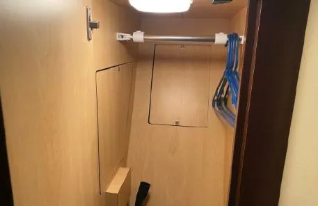 Slide: The Image of 2007 Sea Ray 36 Sedan Bridge interior closet with hangers and light. - 24