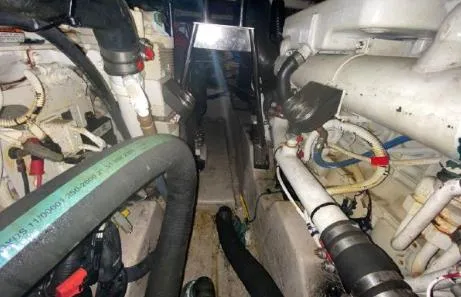 Slide: The Image of Engine room of 2007 Sea Ray 36 Sedan Bridge with visible hoses and machinery. - 34