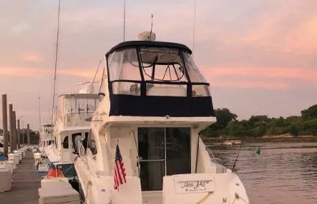 Slide: The Image of 2007 Sea Ray 36 Sedan Bridge yacht docked at sunset with American flag. - 47