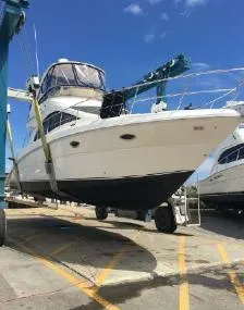 Slide: The Image of 2007 Sea Ray 36 Sedan Bridge yacht on a lift under clear blue sky. - 49