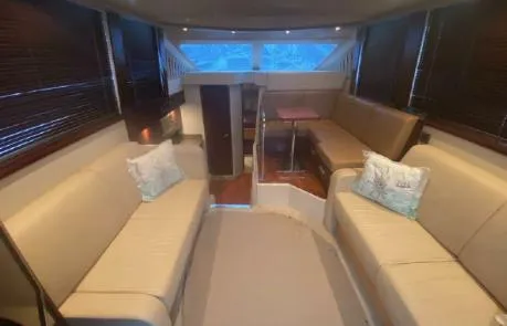 Slide: The Image of Interior of 2007 Sea Ray 36 Sedan Bridge with beige seating and wooden accents. - 5