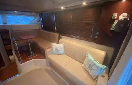 Slide: The Image of Interior of 2007 Sea Ray 36 Sedan Bridge with beige seating and wooden accents. - 6