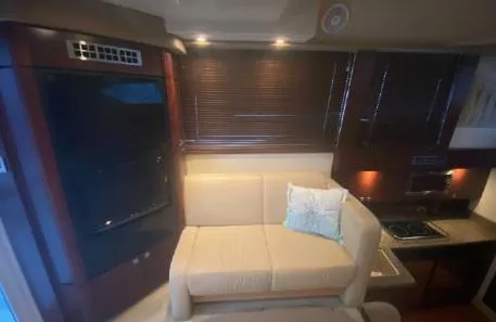 Slide: The Image of Interior of 2007 Sea Ray 36 Sedan Bridge with beige sofa and kitchenette. - 7