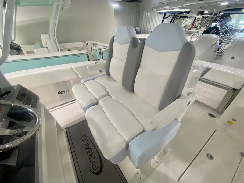 Slide: The Image of 2026 Robalo R250 boat interior with dual white and gray seats. - 19