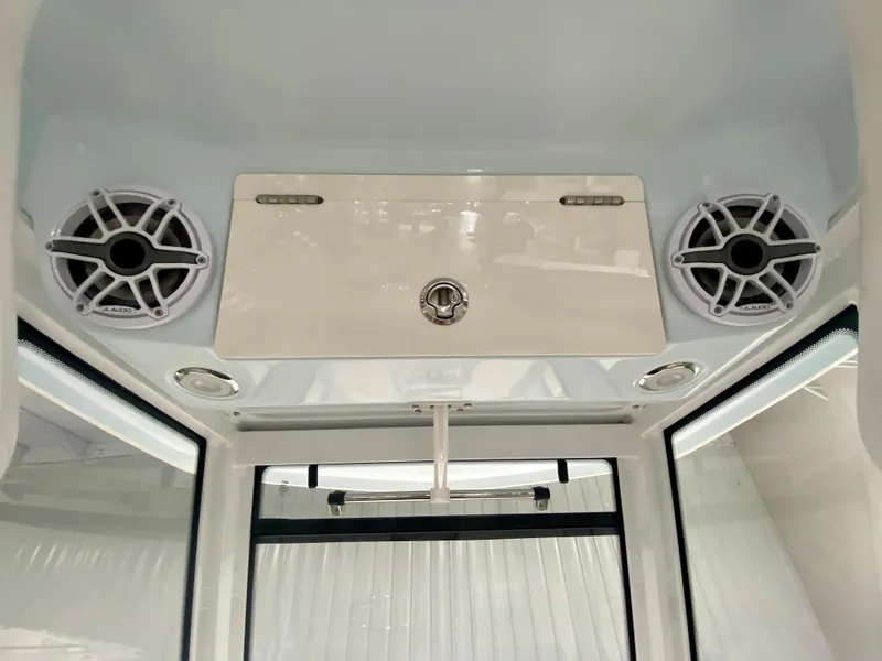 Slide: The Image of 2026 Robalo R250 boat interior with speakers and storage compartment. - 24