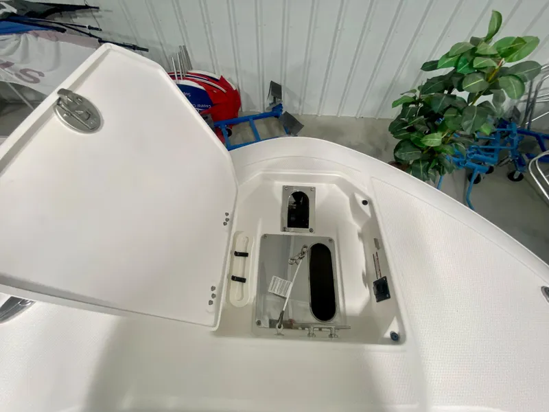 Slide: The Image of Open storage compartment on 2026 Robalo R250 boat, showcasing interior details. - 33