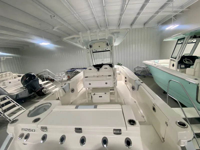 Slide: The Image of 2026 Robalo R250 boat interior in showroom, featuring spacious deck and modern design. - 4