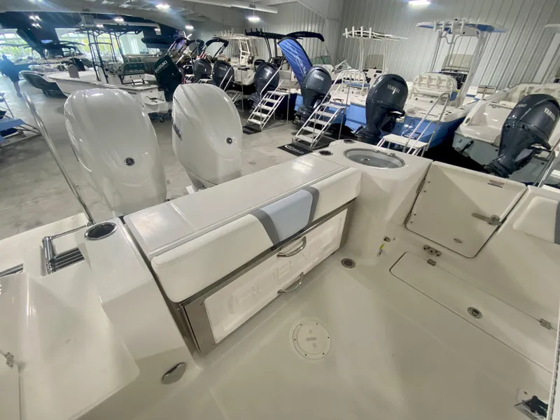Slide: The Image of 2026 Robalo R250 boat interior with dual engines in a showroom. - 5