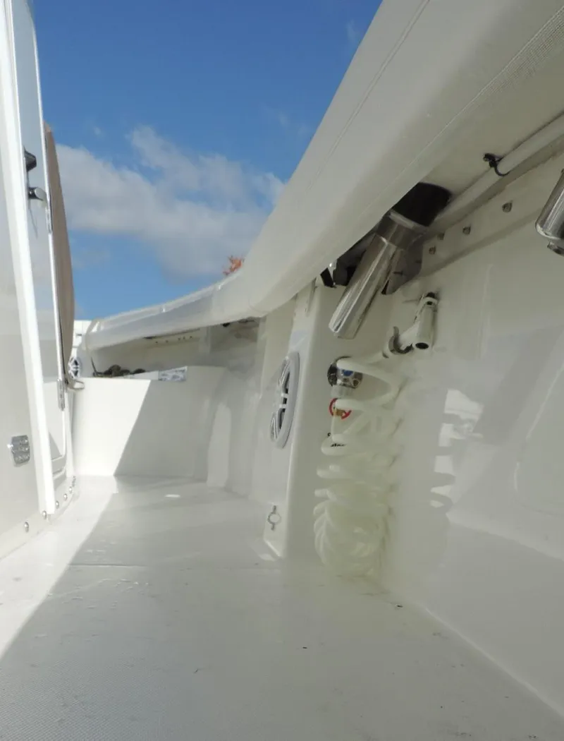 Slide: The Image of 2024 Regulator 23 Center Console boat interior with white deck and blue sky background. - 12