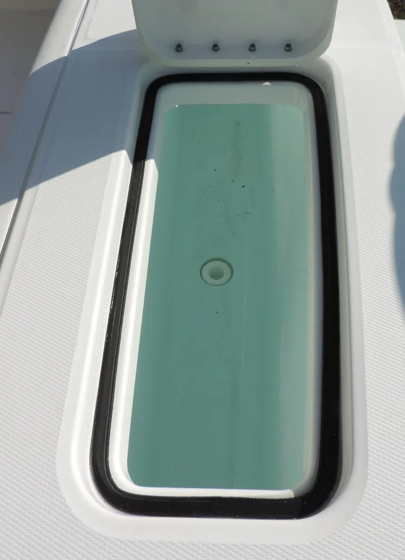 Slide: The Image of 2024 Regulator 23 Center Console livewell with open lid, showcasing interior design. - 13