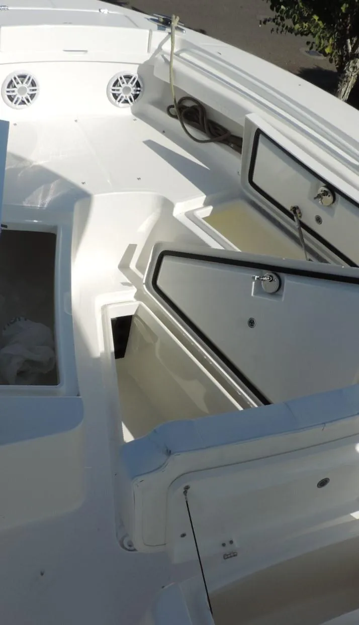 Slide: The Image of 2024 Regulator 23 Center Console boat with open storage compartments and speakers. - 17