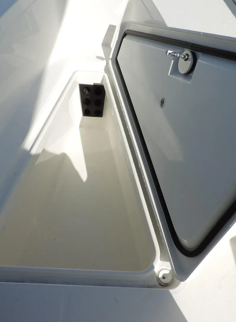 Slide: The Image of 2024 Regulator 23 Center Console storage compartment with open hatch. - 18