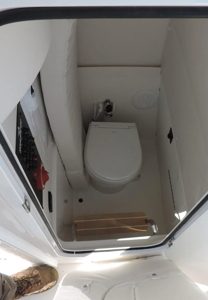 Slide: The Image of 2024 Regulator 23 Center Console boat interior with compact marine toilet. - 27