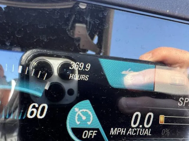 Slide: The Image of Close-up of a 2017 Malibu 23 LSV dashboard showing 369.9 hours and 0.0 MPH. - 10