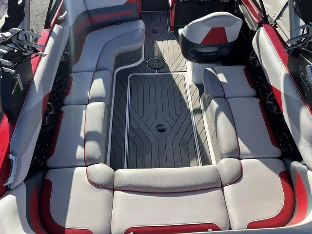 Slide: The Image of 2017 Malibu 23 LSV boat interior with red and gray seating. - 7