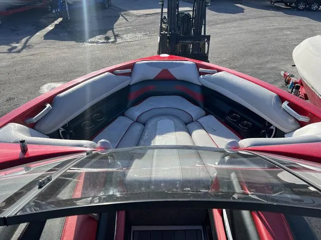 Slide: The Image of Interior view of 2017 Malibu 23 LSV boat with red and gray seating. - 9