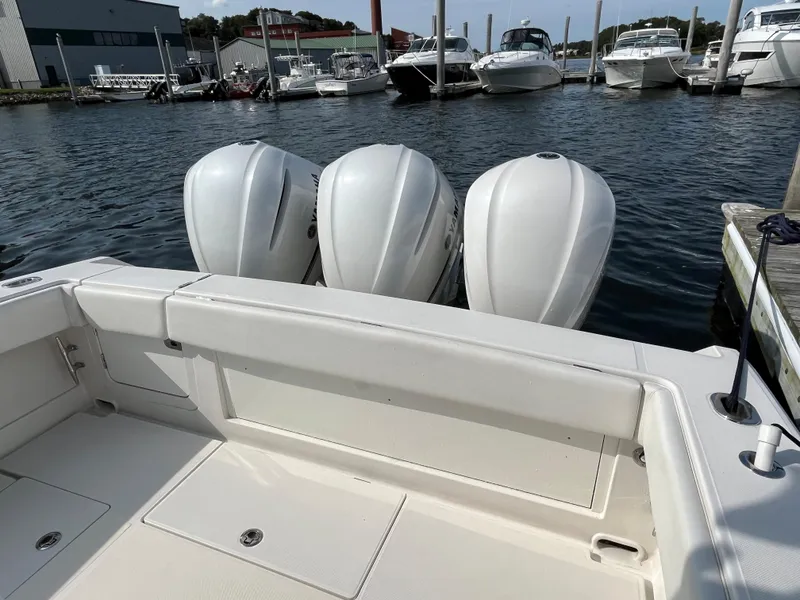 Slide: The Image of 2020 Jupiter 34 Center Console boat with triple outboard engines docked at marina. - 10