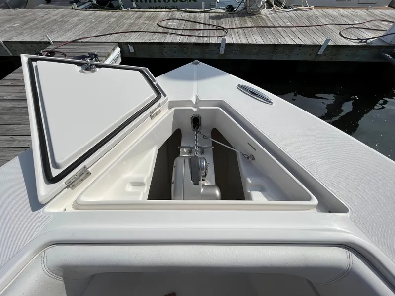 Slide: The Image of 2020 Jupiter 34 Center Console boat anchor compartment at dock. - 15