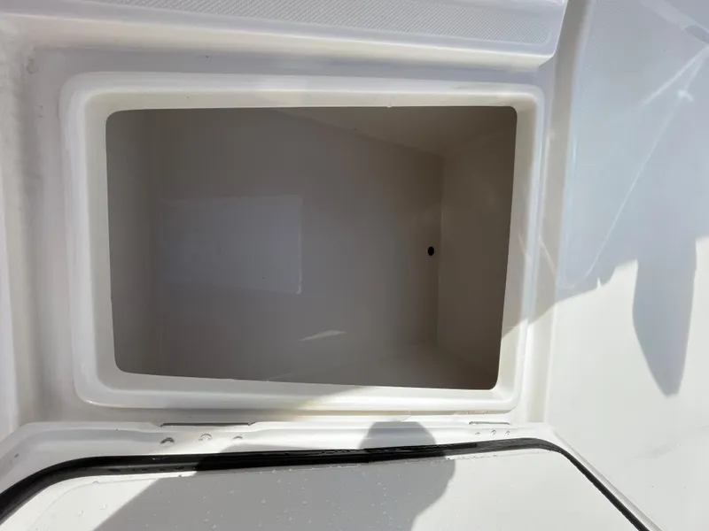 Slide: The Image of Open storage compartment on 2020 Jupiter 34 Center Console boat. - 17