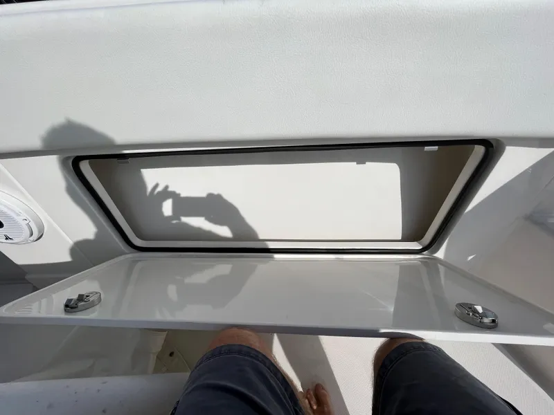 Slide: The Image of Open storage compartment on 2020 Jupiter 34 Center Console boat. - 18