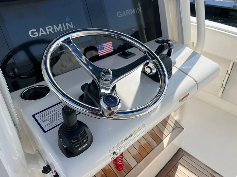 Slide: The Image of 2020 Jupiter 34 Center Console helm with Garmin displays and American flag. - 22