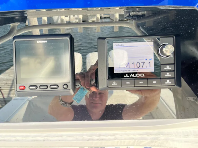 Slide: The Image of 2020 Jupiter 34 Center Console dashboard with Garmin and JL Audio displays. - 25