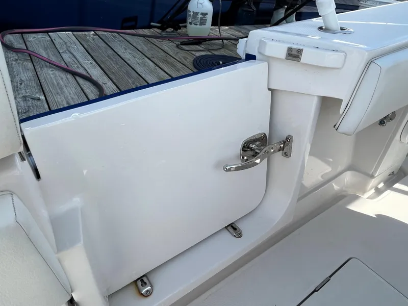 Slide: The Image of 2020 Jupiter 34 Center Console boat with open side door, docked on wooden pier. - 30