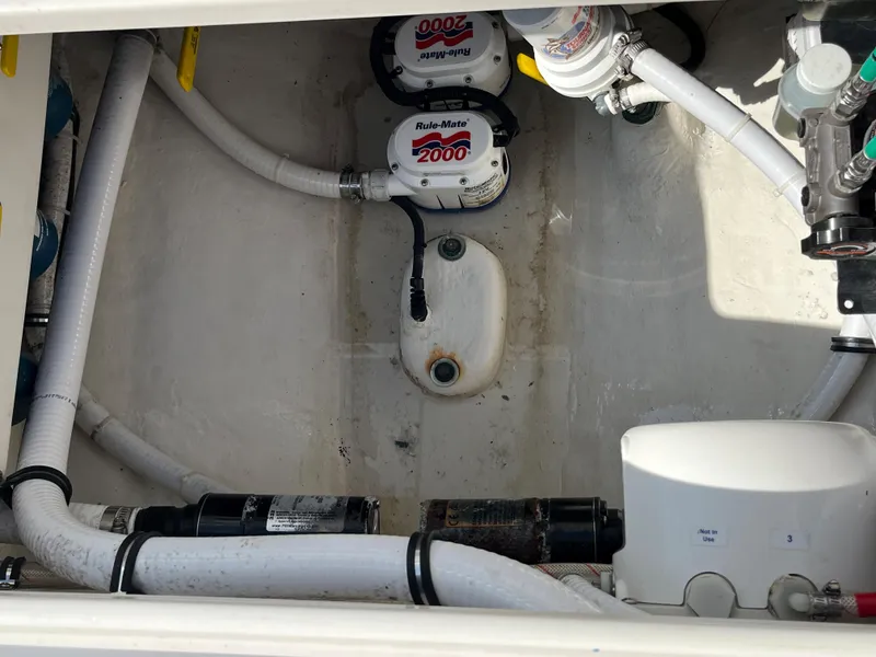 Slide: The Image of 2020 Jupiter 34 Center Console bilge area with pumps and hoses. - 32