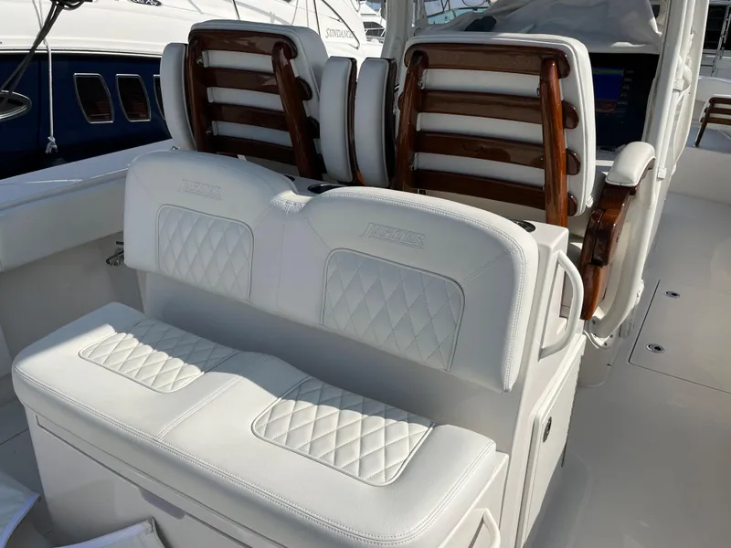 Slide: The Image of Luxurious seating on 2020 Jupiter 34 Center Console boat with elegant white upholstery. - 36