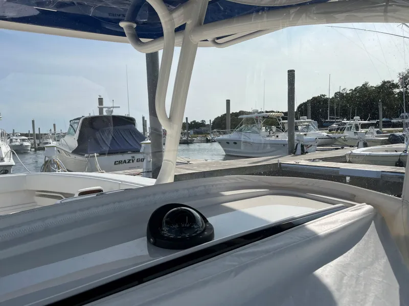 Slide: The Image of 2020 Jupiter 34 Center Console at marina, surrounded by boats. - 38