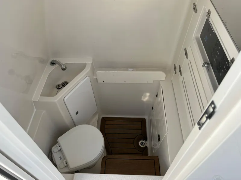 Slide: The Image of 2020 Jupiter 34 Center Console boat bathroom with sink and toilet. - 43