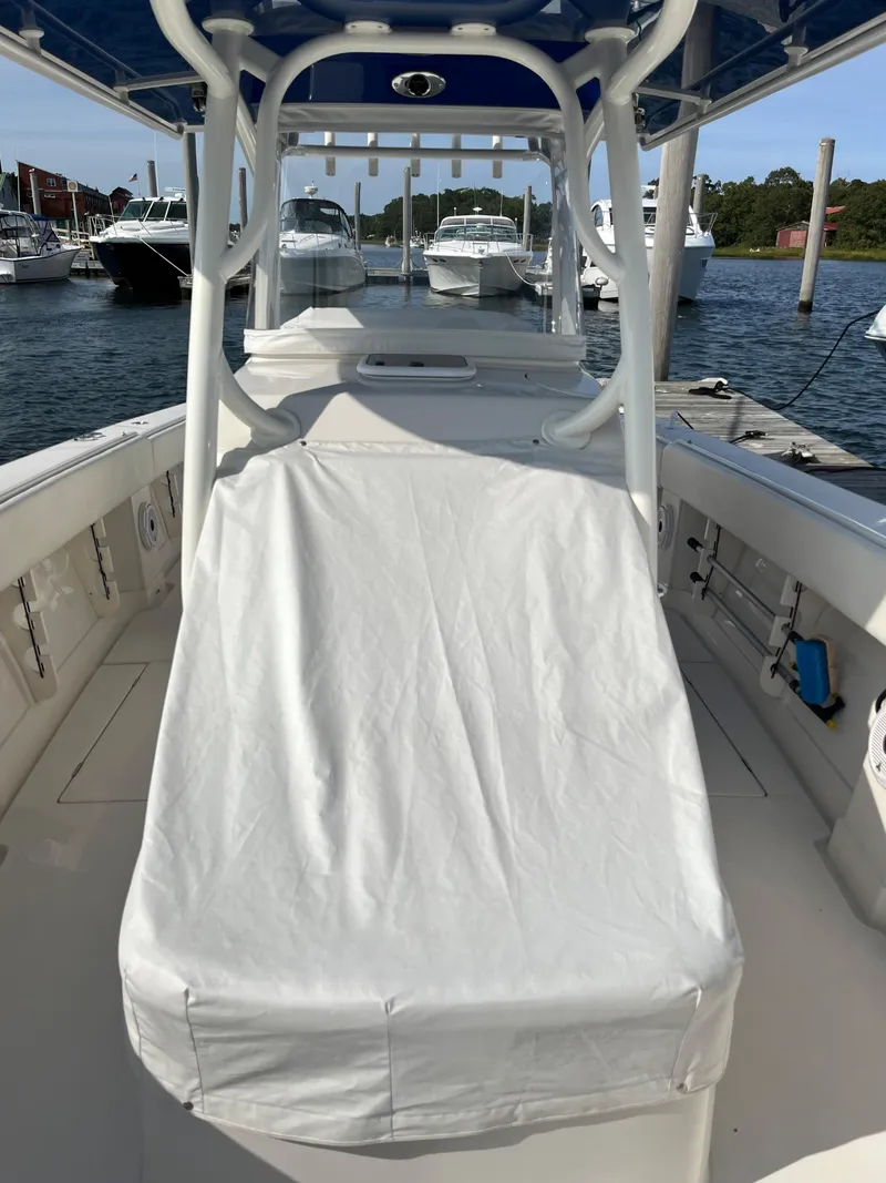 Slide: The Image of 2020 Jupiter 34 Center Console boat with covered seating, docked in a marina. - 45