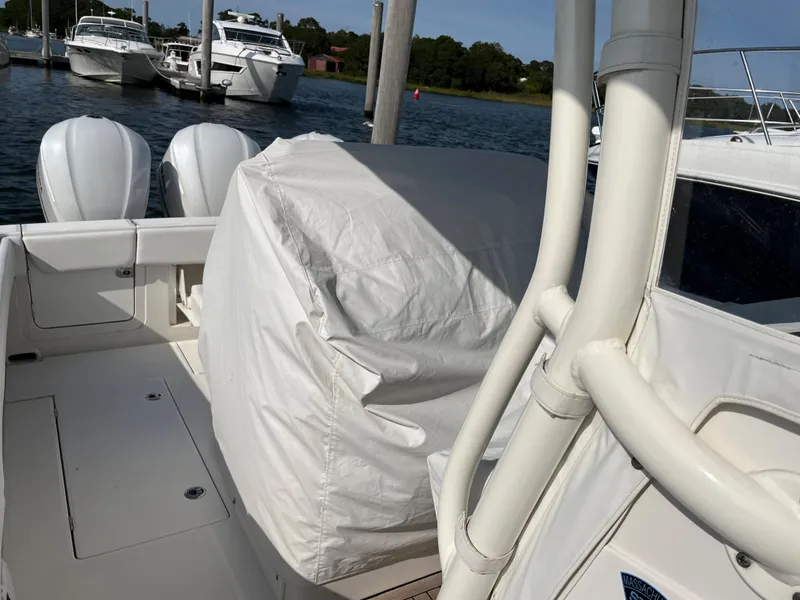 Slide: The Image of 2020 Jupiter 34 Center Console boat docked with covered seating area. - 46