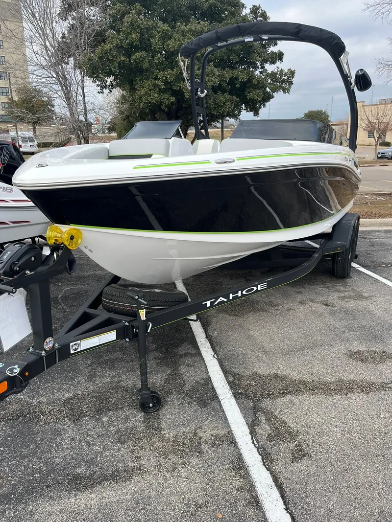 The Image of 2024 Tahoe 210 Si Limited boat on trailer in parking lot. - 0