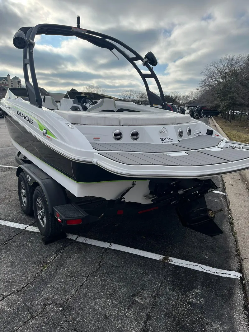 Slide: The Image of 2024 Tahoe 210 Si Limited boat on trailer in parking lot. - 1