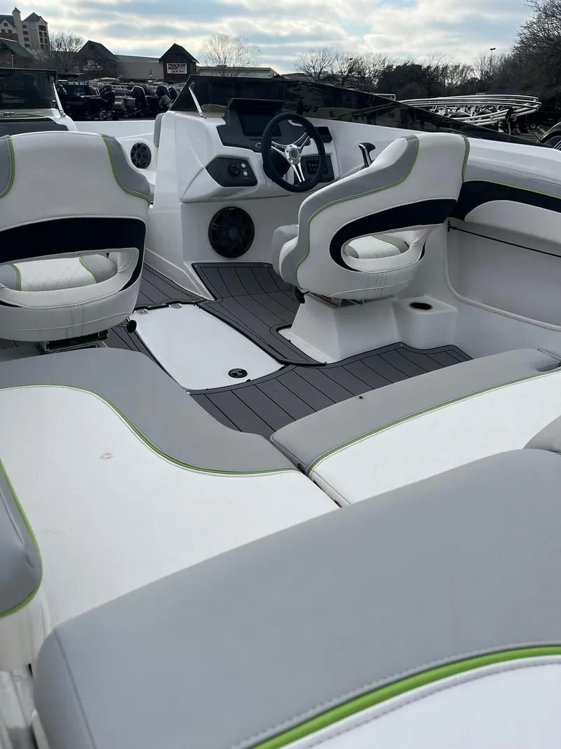 Slide: The Image of 2024 Tahoe 210 Si Limited boat interior with modern seating and dashboard. - 2