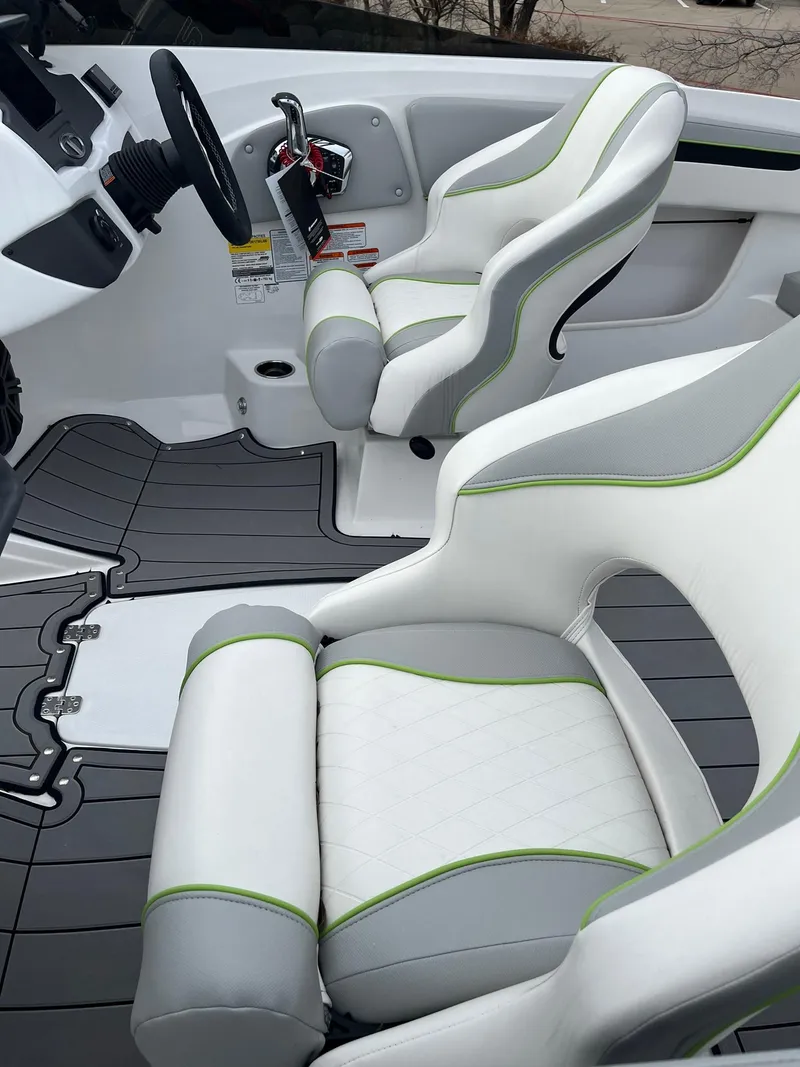 Slide: The Image of 2024 Tahoe 210 Si Limited boat interior with white and gray seats. - 3