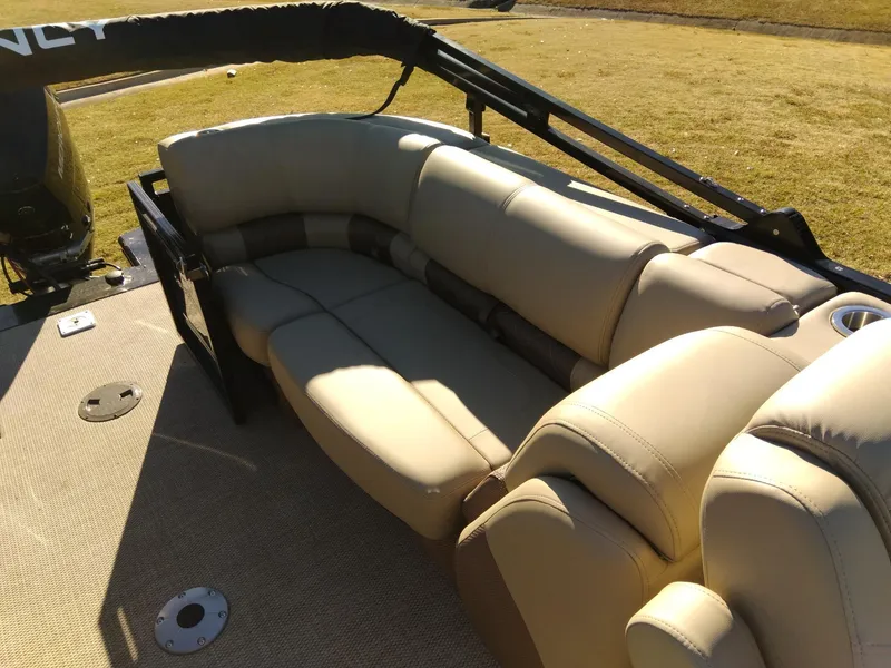 Slide: The Image of 2024 Regency 250 LE3 boat with beige seating and spacious deck. - 11