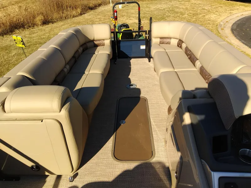 Slide: The Image of 2024 Regency 250 LE3 pontoon boat with spacious seating and modern design. - 12