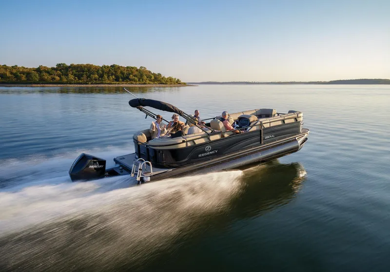 Slide: The Image of 2024 Regency 250 LE3 pontoon boat cruising on a lake with passengers. - 24
