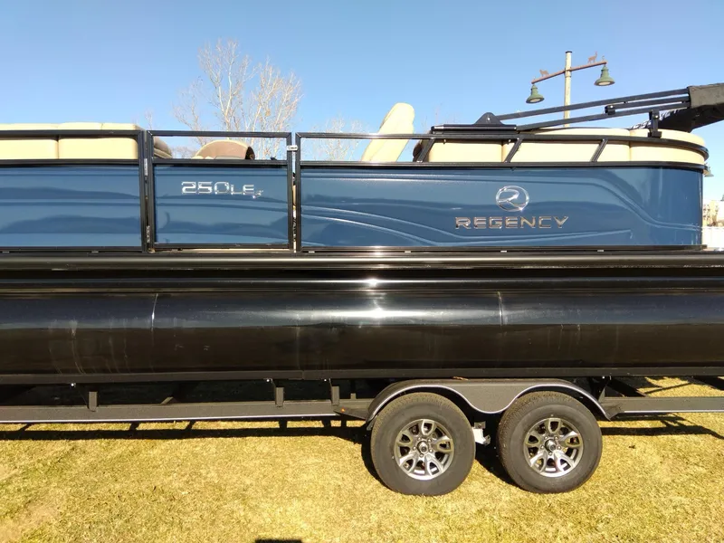 Slide: The Image of 2024 Regency 250 LE3 pontoon boat on a trailer. - 5